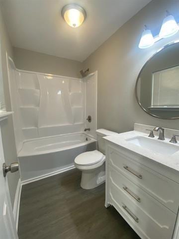 full bathroom with shower / bathtub combination, hardwood / wood-style floors, toilet, and vanity