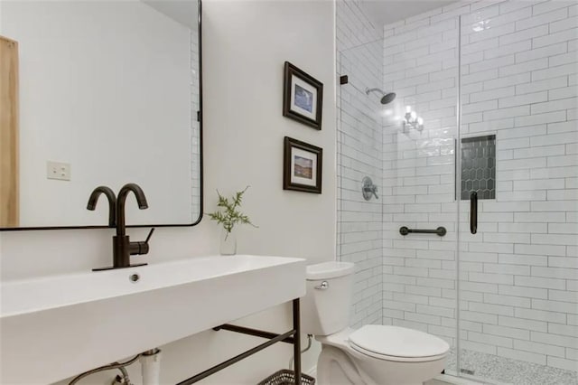 bathroom with walk in shower, toilet, and sink