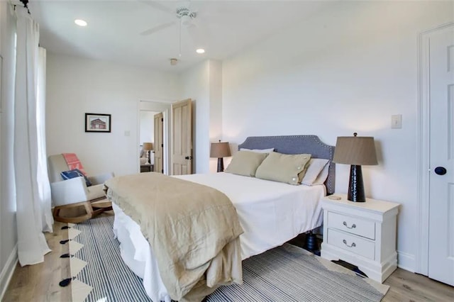 bedroom featuring ceiling fan and light hardwood / wood-style flooring