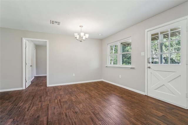 unfurnished dining area featuring a chandelier and dark wood-type flooring