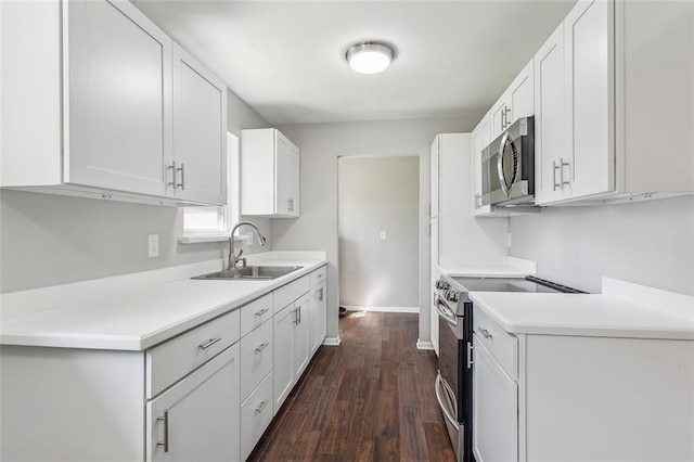 kitchen with dark hardwood / wood-style flooring, stainless steel appliances, white cabinets, and sink