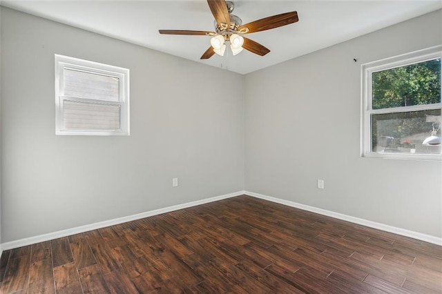 spare room with ceiling fan and dark wood-type flooring