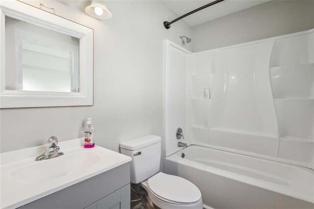 full bathroom with vanity, toilet, and washtub / shower combination