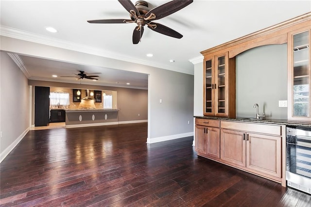 bar featuring dark hardwood / wood-style floors, sink, wine cooler, crown molding, and wall chimney exhaust hood