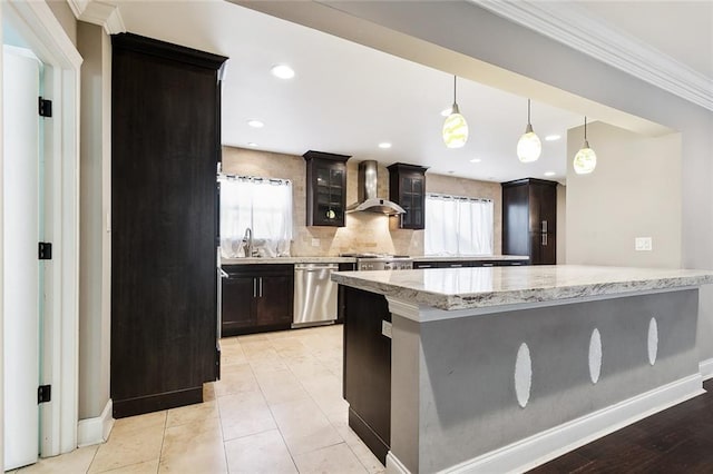 kitchen featuring wall chimney exhaust hood, sink, tasteful backsplash, hanging light fixtures, and dishwasher