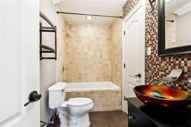 full bathroom featuring tile patterned flooring, backsplash, vanity, toilet, and tiled shower / bath