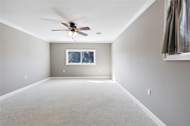 empty room featuring ceiling fan, ornamental molding, and light carpet