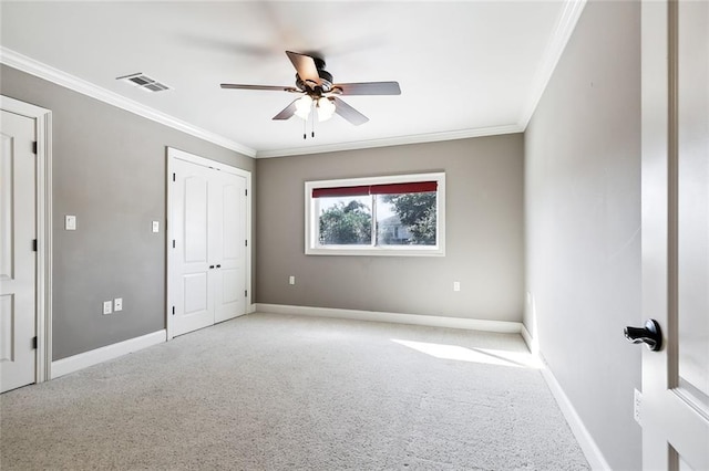 spare room with crown molding, light carpet, and ceiling fan