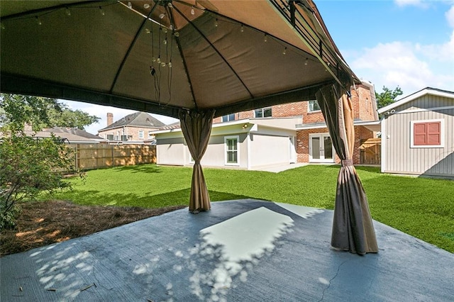 view of patio featuring a gazebo and a storage shed