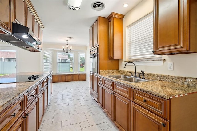 kitchen featuring pendant lighting, sink, range hood, an inviting chandelier, and stainless steel appliances