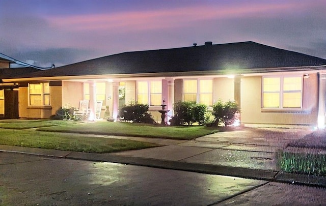 view of front of home with a lawn