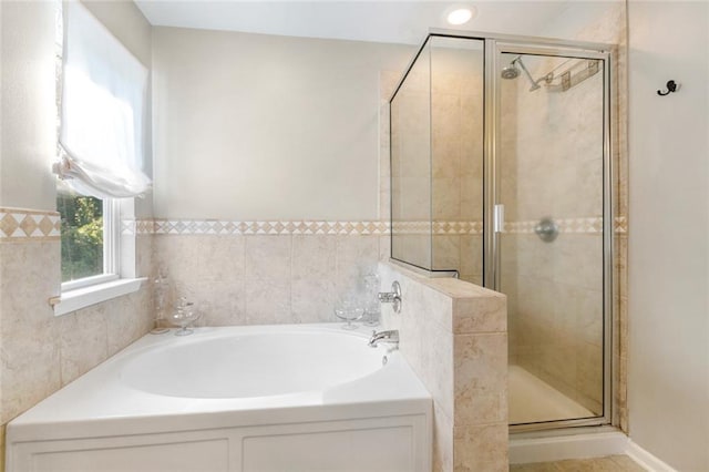 bathroom featuring shower with separate bathtub