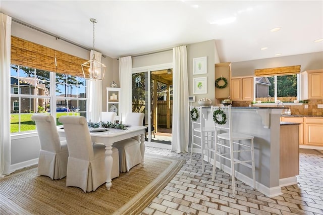 dining room with a healthy amount of sunlight and an inviting chandelier