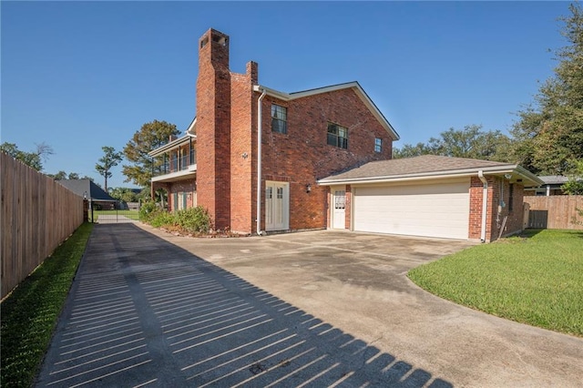 view of side of property with a yard and a garage