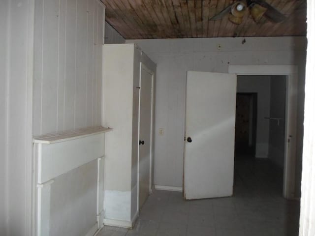 interior space with wood ceiling and wood walls