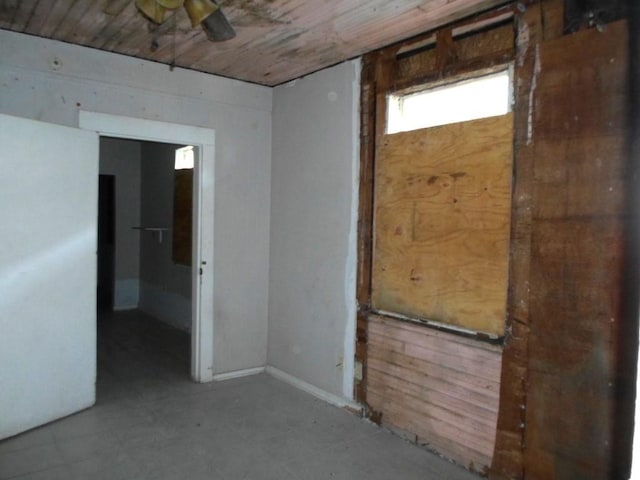 empty room with wooden walls and wooden ceiling