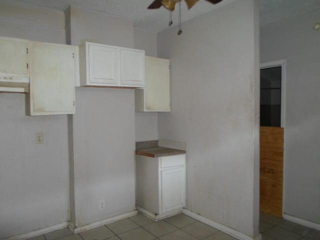 kitchen with light tile patterned flooring, ceiling fan, and exhaust hood