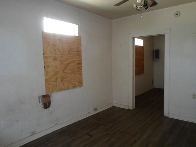 spare room with ceiling fan and dark hardwood / wood-style floors