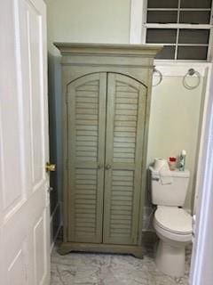 1525 N Derbigny St, New Orleans, LA 70116 - bathroom featuring toilet and marble look tiles