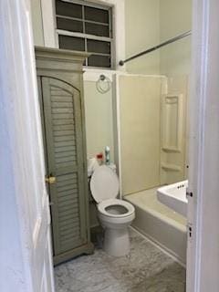 bathroom with toilet and washtub / shower combination