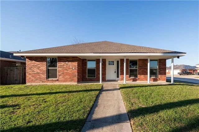 ranch-style house with a porch and a front lawn