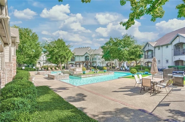 view of pool featuring a jacuzzi, a patio area, and grilling area