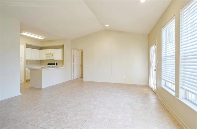 unfurnished living room featuring lofted ceiling and light tile patterned floors