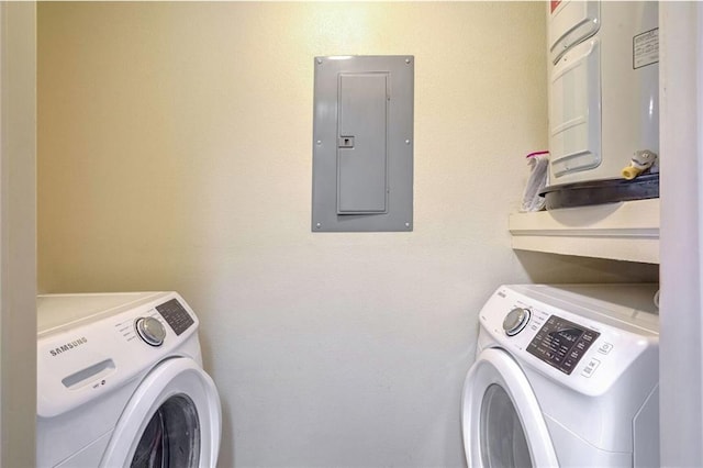 clothes washing area with separate washer and dryer and electric panel