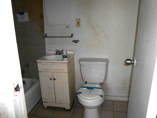 bathroom featuring vanity, tile patterned flooring, toilet, and a tub