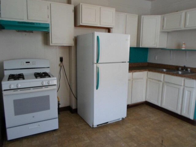 kitchen with decorative backsplash, sink, white appliances, and white cabinetry