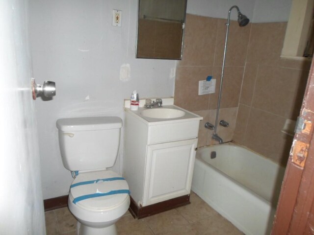 full bathroom featuring vanity, toilet, tile patterned floors, and tiled shower / bath