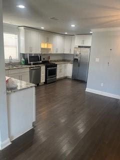 kitchen with stainless steel appliances, white cabinets, sink, and dark hardwood / wood-style flooring