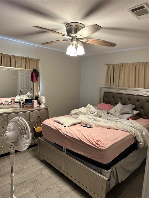 bedroom featuring ceiling fan and light hardwood / wood-style floors