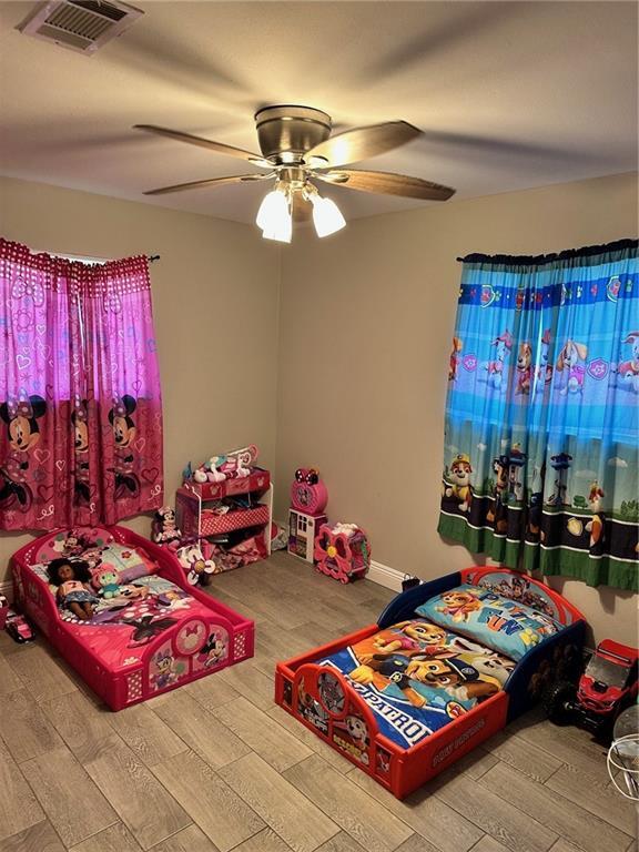 bedroom featuring hardwood / wood-style flooring and ceiling fan