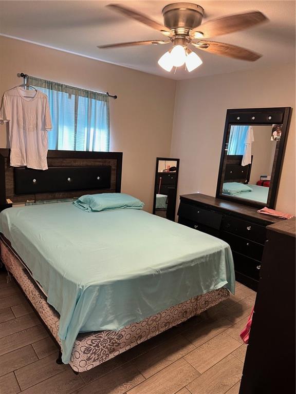 bedroom featuring ceiling fan and light hardwood / wood-style floors