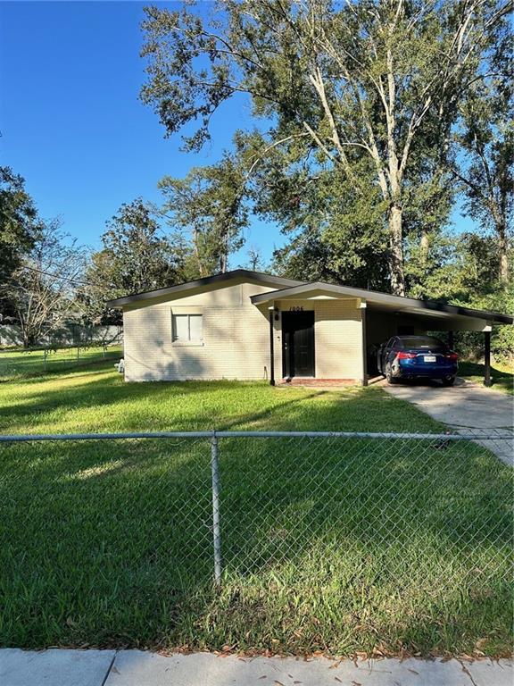 view of front of house with a front lawn and a carport