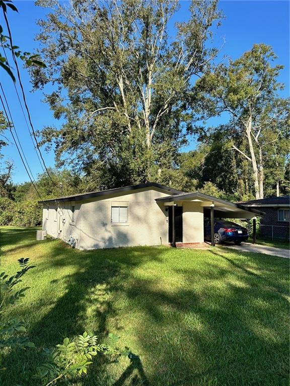 exterior space with a yard and a carport