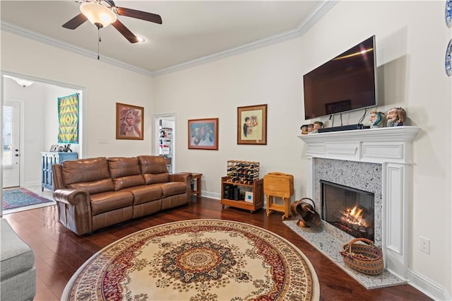 640 Pine Grove Loop, Madisonville, LA 70447 - living area with crown molding, a ceiling fan, wood finished floors, and a premium fireplace