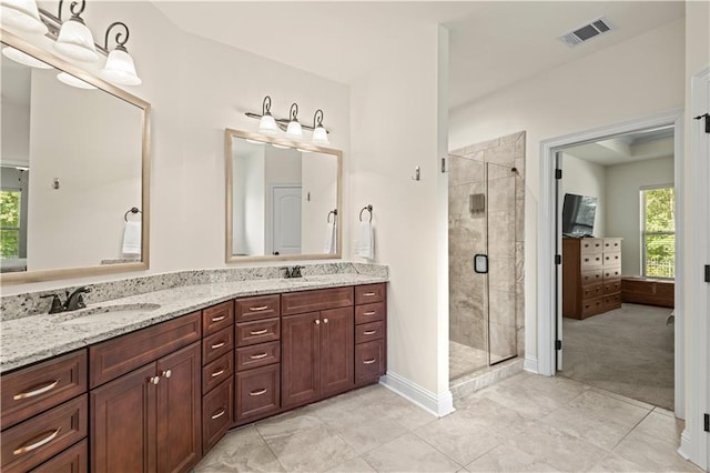 bathroom featuring vanity, tile patterned floors, and an enclosed shower