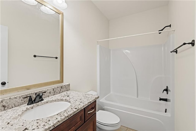 full bathroom with vanity, tile patterned floors, washtub / shower combination, and toilet