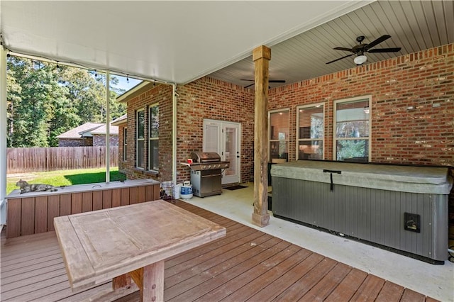 wooden deck featuring a hot tub, a grill, and ceiling fan