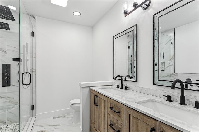 bathroom featuring a shower with door, vanity, and toilet