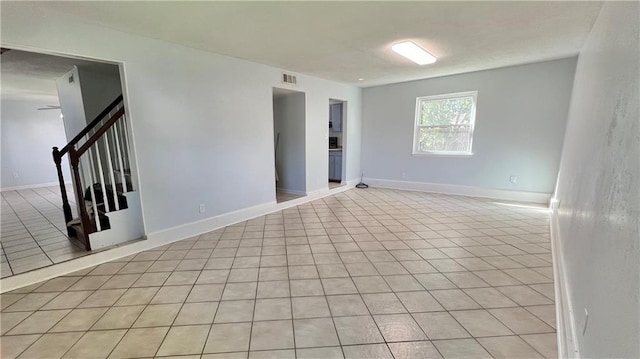420 Lacour Dr, La Place, LA 70068 - unfurnished room featuring stairs, light tile patterned floors, and baseboards