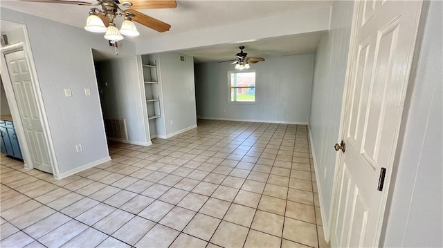 tiled empty room with ceiling fan