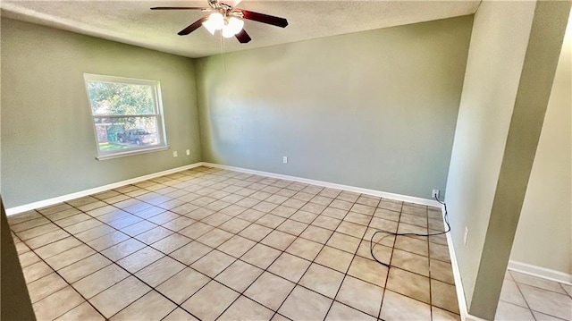 tiled spare room with ceiling fan and a textured ceiling