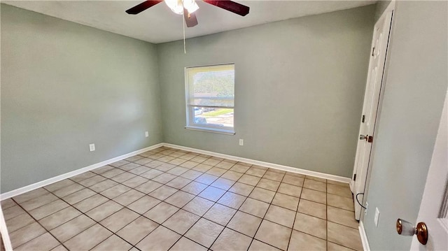 spare room with ceiling fan and light tile patterned floors