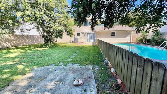 view of yard featuring cooling unit and a fenced in pool