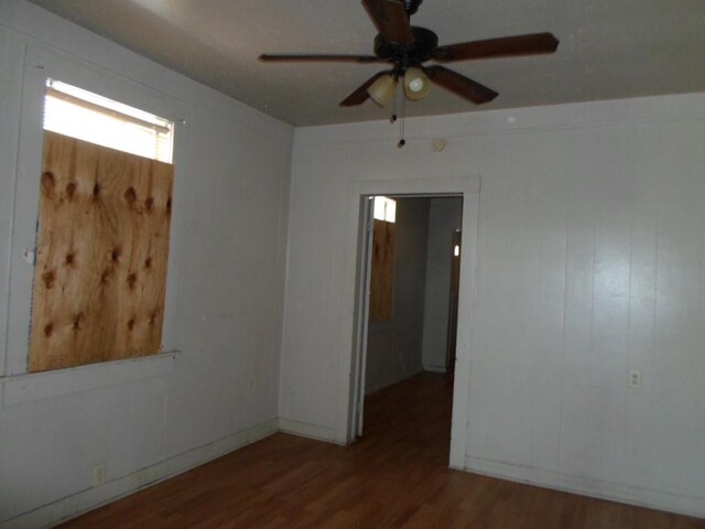 empty room featuring hardwood / wood-style floors and ceiling fan