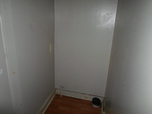 clothes washing area featuring dark hardwood / wood-style flooring