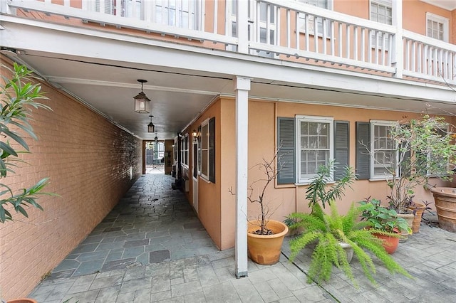 view of exterior entry with a balcony